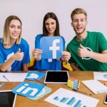 smiling-woman-holding-facebook-logo-with-his-friends-showing-thumbup-sign_23-2147847473 smiling-woman-holding-facebook-logo-with-his-friends-showing-thumbup-sign_23-2147847473